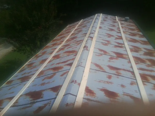 Rusted metal roof panels with new wood purlins before replacement — Storm Damage Roof Repair in Kimberton by Roofing Brothers