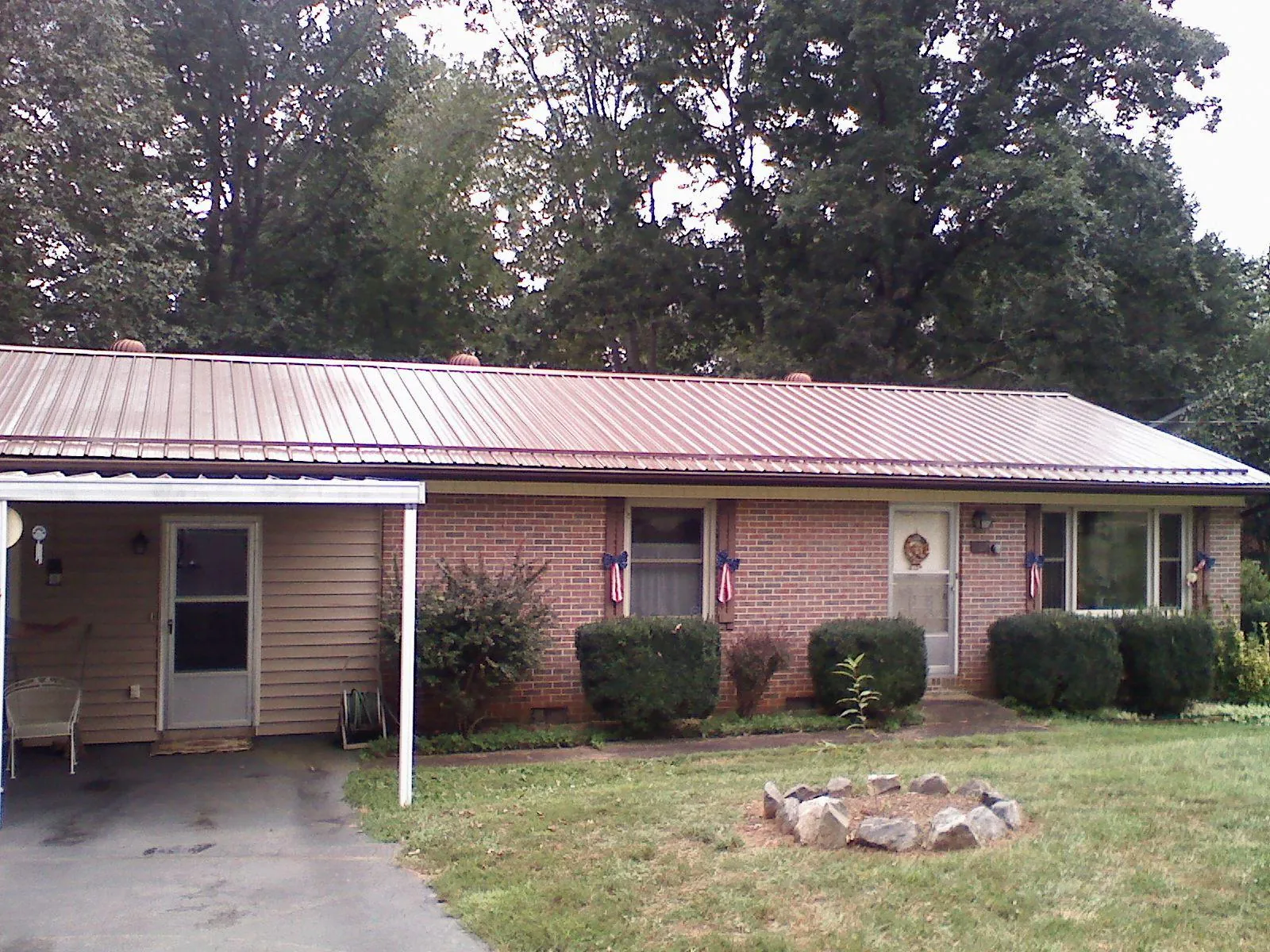 Bronze metal roof and carport on a brick ranch home — Roof Repair work by our crew in Kimberton